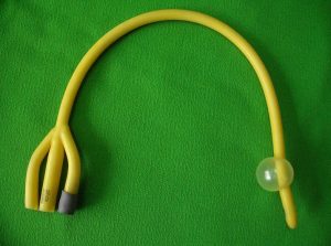 A urinary catheter with a balloon at one end