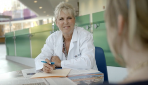Clinician sitting with a patient at ICORD in discussion