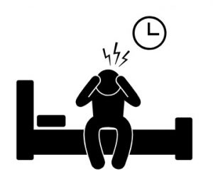 A cartoon person sitting on the side of the bed holding his head with zigzags above the head and a clock on the wall