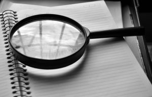 Magnifying glass lying on top of a notebook