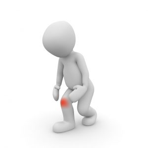 Stock image of figure experiencing knee pain