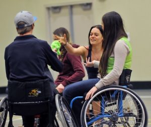 A group of people on wheelchairs socializing with each other