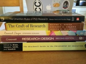 A stack of textbooks on research