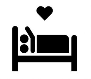 A silhouette of two people in bed with a heart above